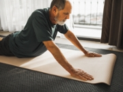 A man stretches to support back health.