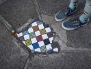 Artist turns potholes into colorful mosaics