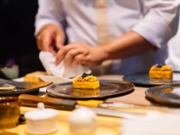 Close up hand of Japanese Sushi chef using torch burning  tuna sushi for customer omakase course