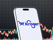 QIANJIANG, CHINA - FEBRUARY 23: In this photo illustration, a smartphone displays the logo of The Kroger Co. (NYSE: KR), an American retail company operating supermarkets and multi-department stores across the United States, in front of a screen showing the company's latest stock market chart on February 23, 2026 in Qianjiang, Hubei Province, China. (Photo illustration by Cheng Xin/Getty Images)