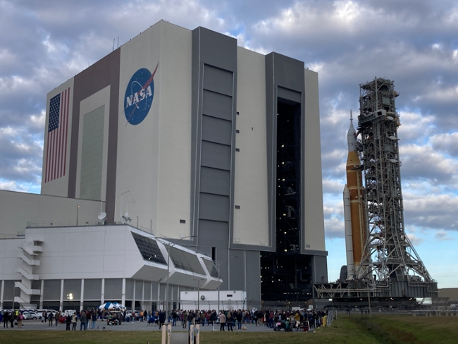 The crawler-transporter 2 with the Space Launch System rocket and Orion spacecraft rolls outside the Vehicle Assembly Building at Kennedy Space Center as it rolls out for Artemis II on Jan. 17, 2026. (Richard Tribou/Orlando Sentinel/Tribune News Service via Getty Images)