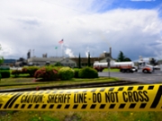LONGVIEW, WASHINGTON - MAY 26: Emergency tape reading "Caution: Sheriff Line - Do Not Cross" is seen in front of the Nippon Dynawave Packaging facility following a fatal chemical storage tank implosion on May 26, 2026 in Longview, Washington. Authorities confirmed in a statement that there were fatalities and multiple critical injuries after the pulp and paper mill implosion, but no specific numbers were provided. (Photo by Mathieu Lewis-Rolland/Getty Images)