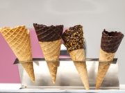 A variety of ce cream cones lined up, with a shallow depth of field