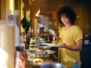 A young woman having lunch at an Indian buffet restaurant.