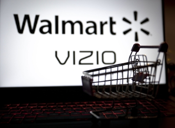 ANKARA, TURKIYE - MARCH 06: In this photo illustration, a market cart model is seen in front of the logos of Walmart and Vizio displayed on a computer screen in Ankara, Turkiye on March 06, 2024. (Photo by Betul Abali/Anadolu via Getty Images)