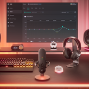 Desk with RGB lights surrounding keyboard, mic, headset and monitor