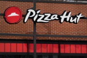 CHICAGO, ILLINOIS - FEBRUARY 09: A sign hangs above the front of a Pizza Hut restaurant on February 09, 2026 in Chicago, Illinois. Yum! Brands, the parent company of Pizza Hut, said it will close 250 Pizza Hut restaurants in the first half of the year, roughly 3% of its U.S. footprint. (Photo by Scott Olson/Getty Images)