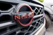 SAN DIEGO, CALIFORNIA - NOVEMBER 11: A Nissan logo is displayed on a used truck for sale at a dealership on November 11, 2025 in San Diego, CA. (Photo by Kevin Carter/Getty Images)