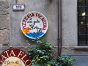 Corniglia Italy - April 26 2011; Exterior of La Gata Flora restaurant with sign o plate on wall