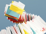 Digitally generated images of dynamic and colorful array of file folders, arranged in a swirling circular pattern against a light blue background. How digital solutions can help streamline the organization of physical documents, making them easily accessible and securely stored