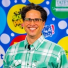 Smiling man in green checkered shirt