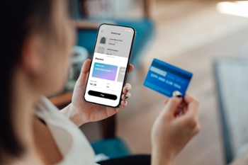 Woman using her debit card for online shopping