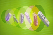 11 piles of US $100 bills passing through green and yellow abstract graphic tunnel