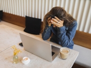 Business woman looking worried, upset, stressed, exhausted or in pain working on a laptop computer. Frustrated woman resting while working on laptop.