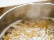 Cooking spaghetti pasta in a pot with boiling water.