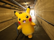 A Pikachu character walks through a tunnel after posing for pictures with fans as people play the Pokemon GO game on smartphones during the in-person Pokemon GO Tour: Kalos Los Angeles 2026 event at the Rose Bowl Stadium in Pasadena, California on February 20, 2026. Pokemon fans around the world continue to engage with the media franchise in various formats including video games, trading cards, animated series, and movies ahead of the 30th anniversary of Pok&eacute;mon next week. (Photo by Patrick T. Fallon / AFP via Getty Images)