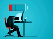 Employee hunched over desk with low battery symbol above