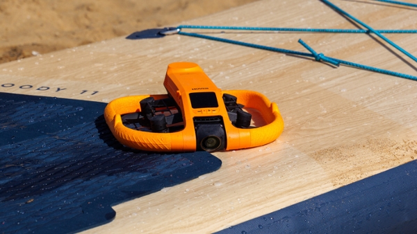 Yellow HoverAir Aqua on a wooden surface
