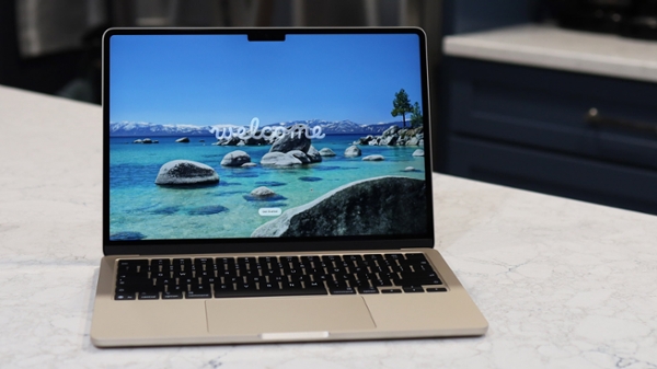 MacBook Air open a table with image of seashore on screen