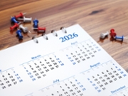 3d render March 2026 Calendar Stands on Wooden Background with Colorful Pushpins, Christmas and New Year Concept