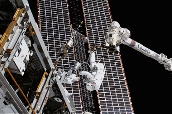 NASA astronauts on spacewalk replace faulty antenna outside space station