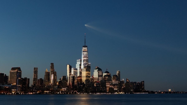 a bright streak of light over a city skyline