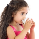 Little girl is drinking milk