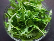 Close-up of arugula in bowl on table