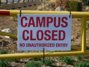 Sign on gate stating school campus is closed due to coronavirus pandemic