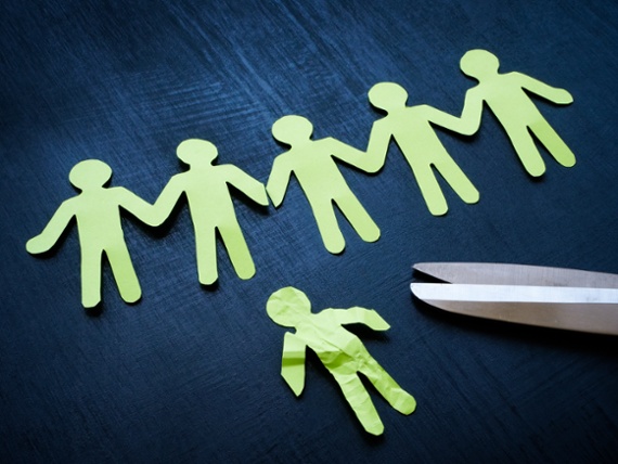 Line of paper figures and one crumpled cut off. Dismissal or occupational stress.