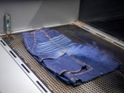 MASERU, LESOTHO - JULY 2: A Jeanologia laser marking machine engraves a denim skirt on July 2, 2025 in Ha Thetsane Industrial Area in Maseru, Lesotho. Lesotho garment manufacturer Presitex makes denim and exports exclusively to the South African jeans market. It is the largest garment factory in Lesotho, employing over 2000 workers. (Photo by Per-Anders Pettersson/Getty Images)