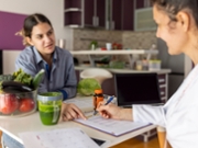 Female doctor nutritionist, dietician and her patient on consultation in the office.