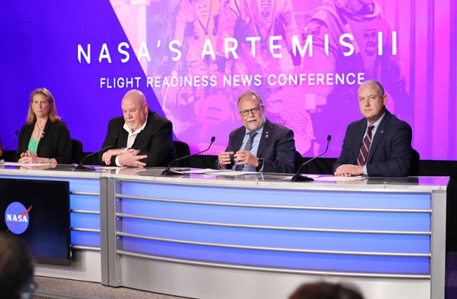 (L/R) Lori Glaze, acting associate administrator, Exploration Systems Development Mission Directorate, John Honeycutt, chair, Artemis II Mission Management Team, Shawn Quinn, manager, Exploration Ground Systems Program and Norm Knight, director, Flight Operations Directorate participate in a press conference about revisions and fixes being done to numerous Artemis II rocket components at the Kennedy Space Center in Cape Canaveral, Florida, on March 12, 2026. NASA rolled the massive Space Launch System rocket and Orion spacecraft back to the Vehicle Assembly Building from Launch Pad 39B on February 25 to troublshoot problems encountered during a wet dress rehearsal. NASA engineers and technicians will effect repairs and replace numerous flight batteries prior to sending four astronauts to the moon for the first time in more than 50 years. Artemis II is scheduled to launch in April. (Photo by Gregg Newton / AFP via Getty Images)