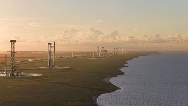 tall metal towers on a shoreline at sunset