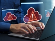 Businessperson using laptop computer with cloud outage symbol